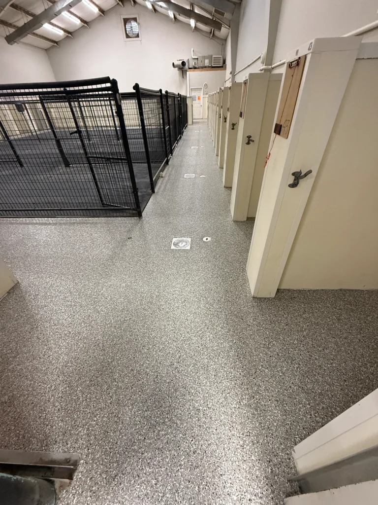 Dog kennel floor protected with epoxy flake coating