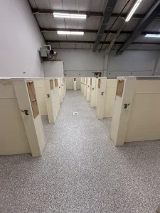 Dog kennel floor protected with epoxy flake coating
